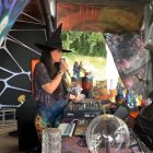 Colorful psychedelic witch DJ booth scene with swirling patterns