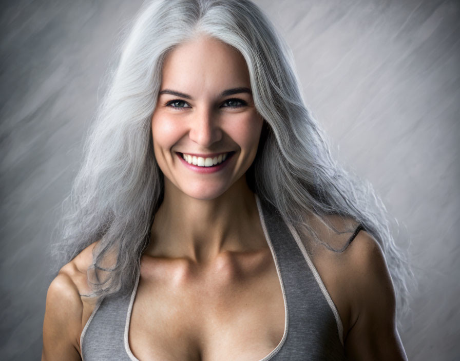 Silver-haired woman in gray tank top on textured backdrop