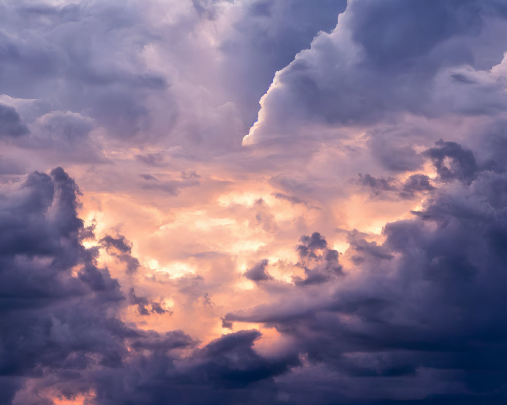 Dramatic sky with billowing clouds in purple, blue, and orange.