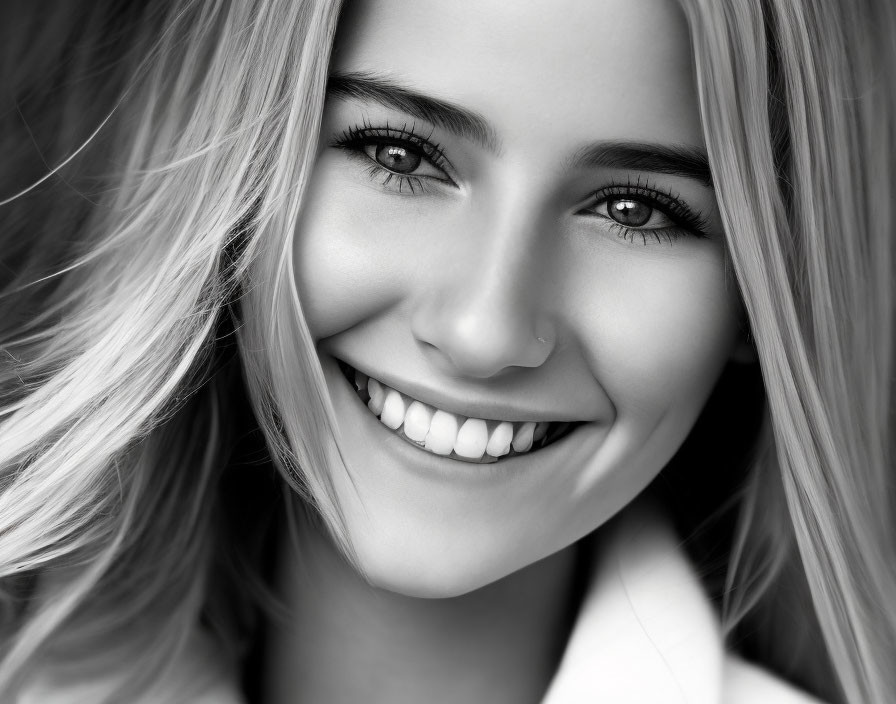 Smiling young woman with blonde hair and nose piercing portrait