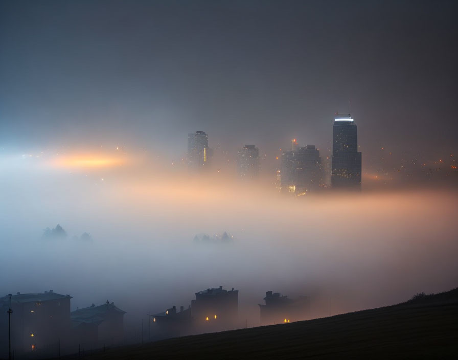 Foggy city skyline at dusk with illuminated buildings