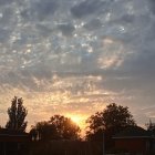 Military vehicles and explosion at sunset with flag pole in dramatic scene