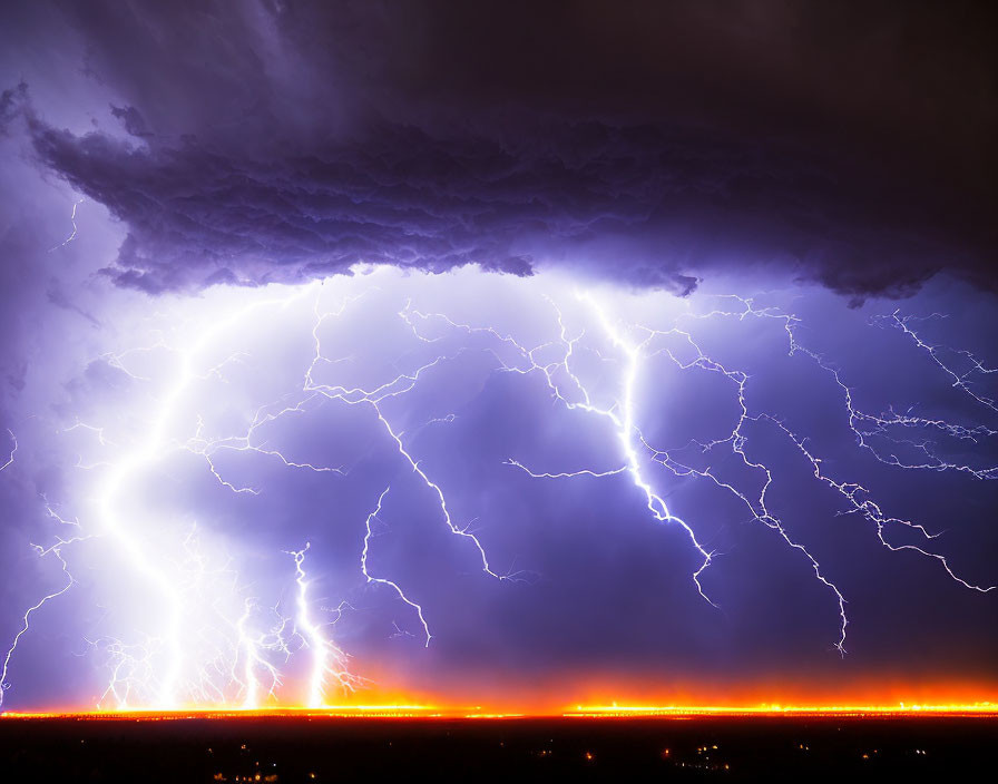 Intense lightning storm illuminating night sky