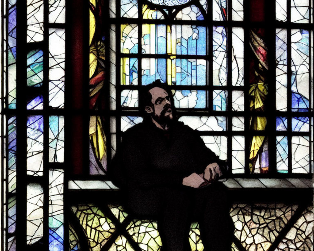 Bearded man in contemplation by colorful stained glass window