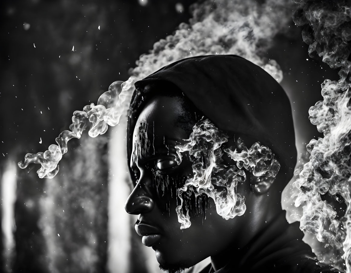 Portrait of person in beanie with swirling smoke, in dramatic black and white.