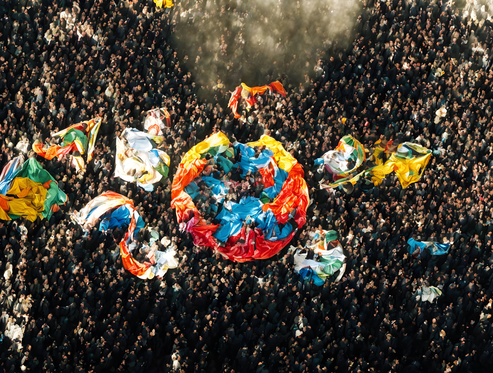 Vibrant crowd with colorful flags from above