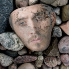 Hyper-realistic painting: Elderly man's face among rocks