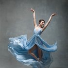 Dancer in Blue Dress Surrounded by Petals and Leaves