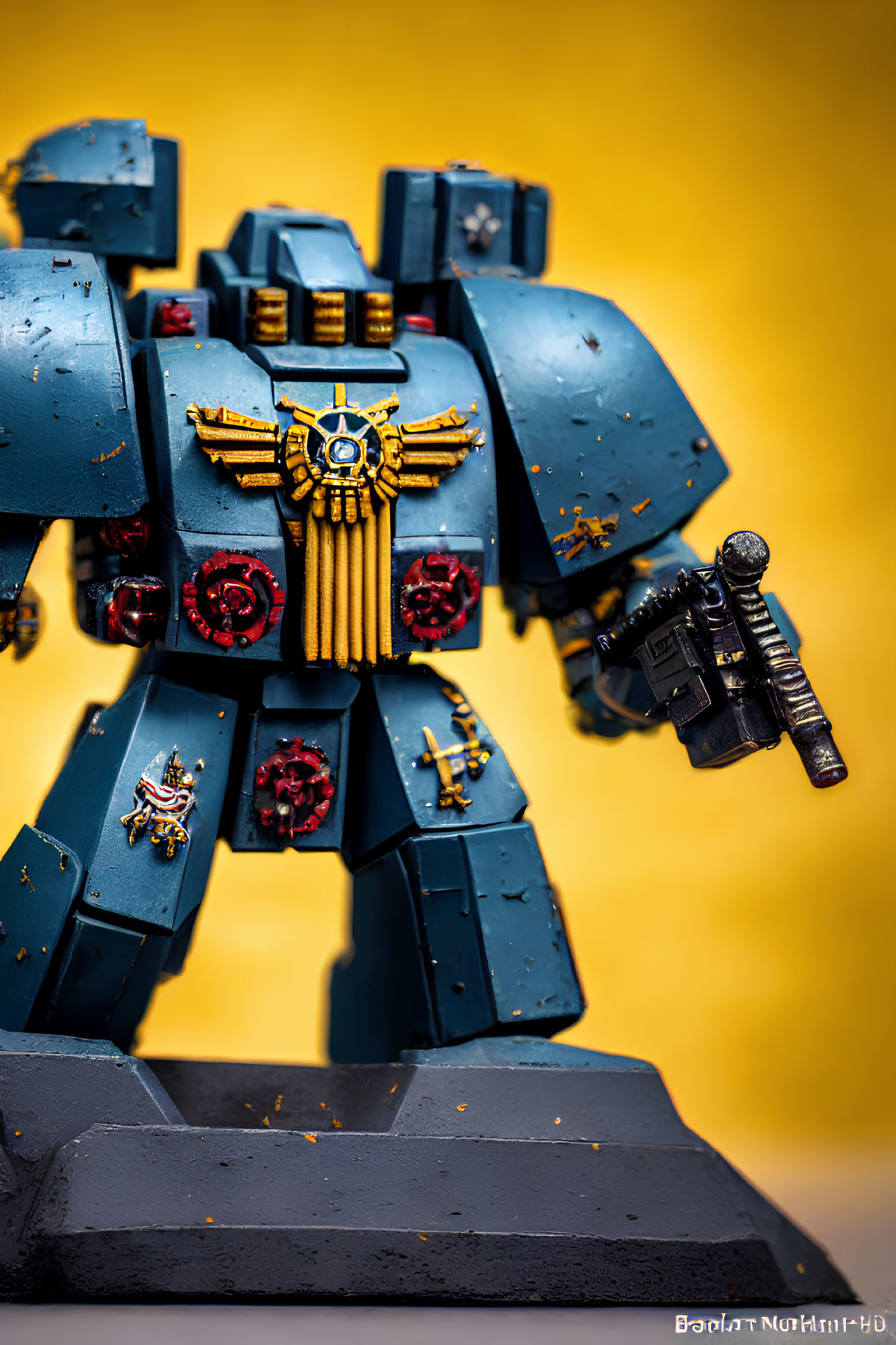 Detailed Blue and Gold Mech Suit Miniature on Vivid Yellow Background