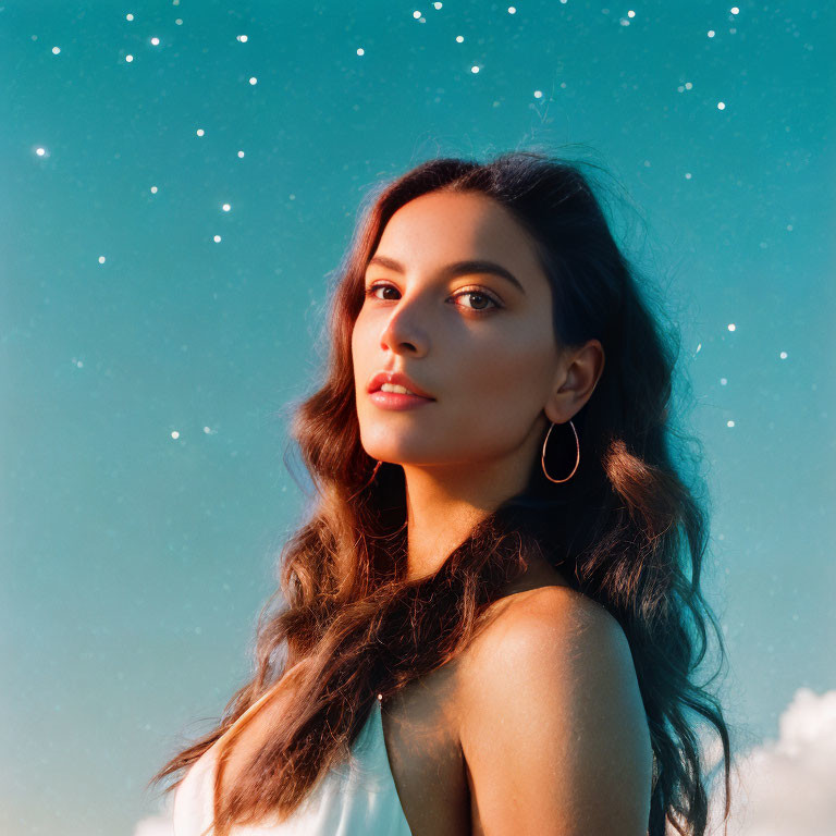 Dark-haired woman in hoop earrings gazes over shoulder under starry sky