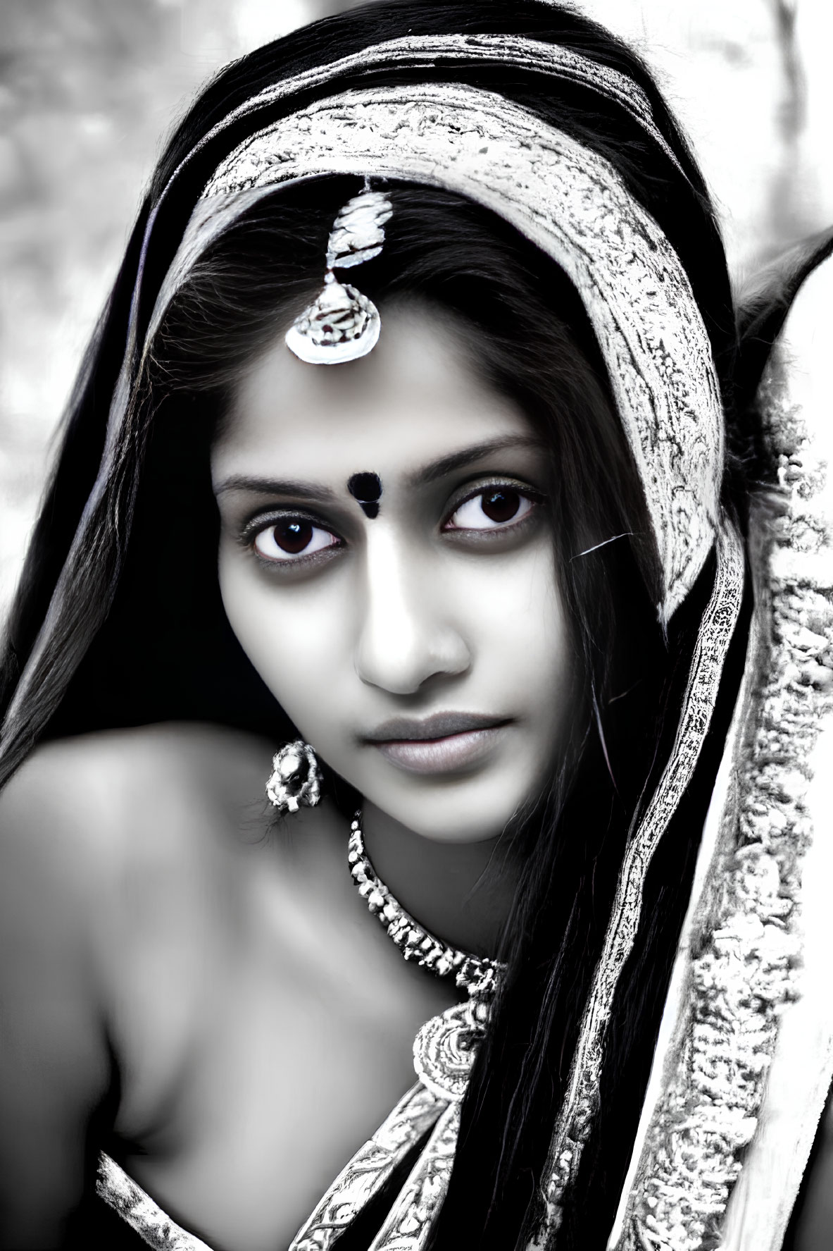 Monochrome portrait of woman in traditional Indian jewelry