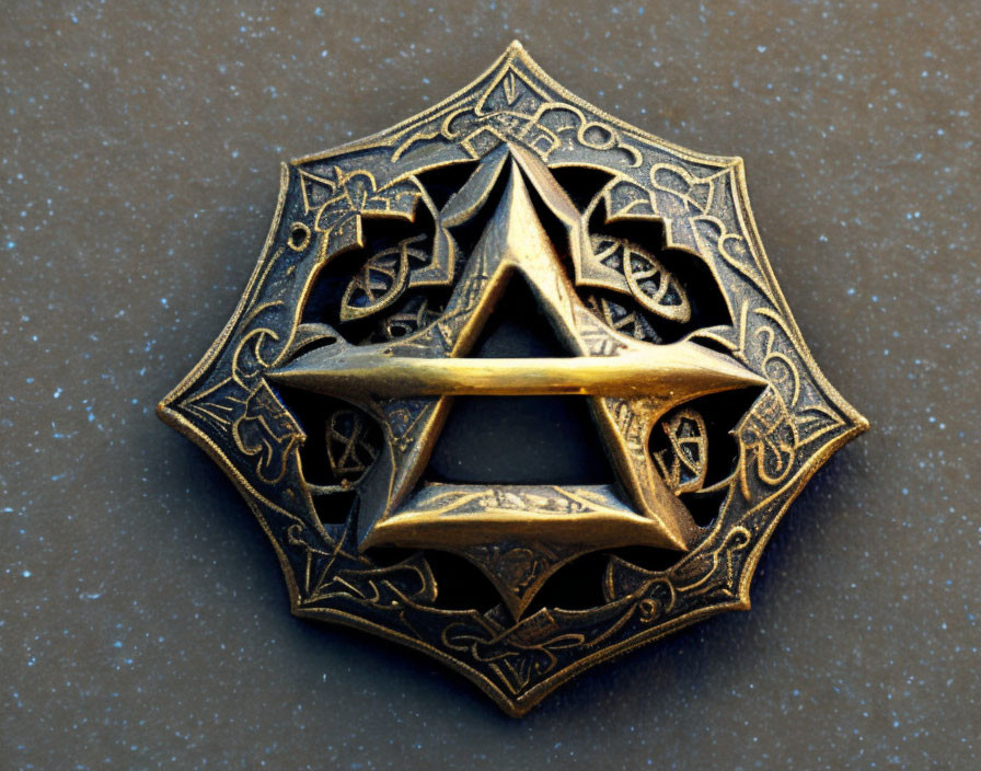 Intricate Engraved Brass Star Pendant on Dark Background