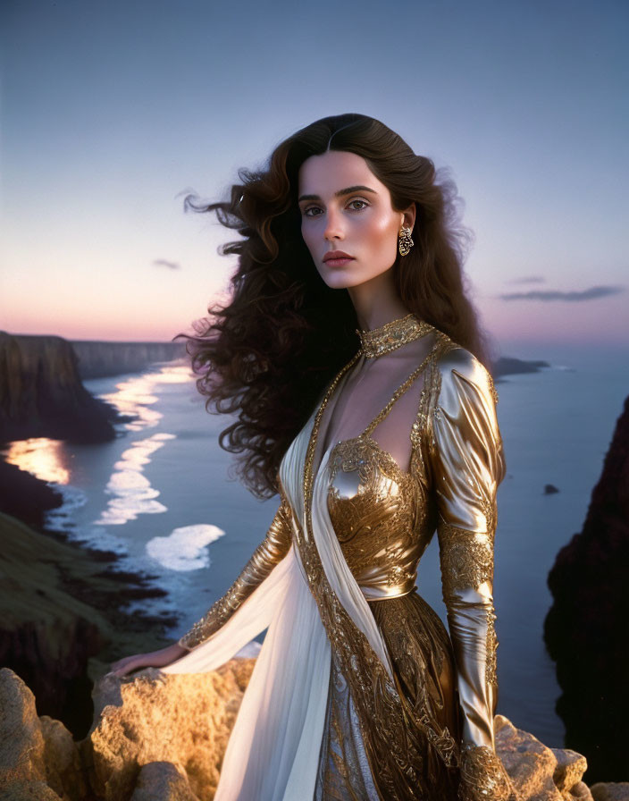 Woman in Gold and White Dress on Cliff at Sunset