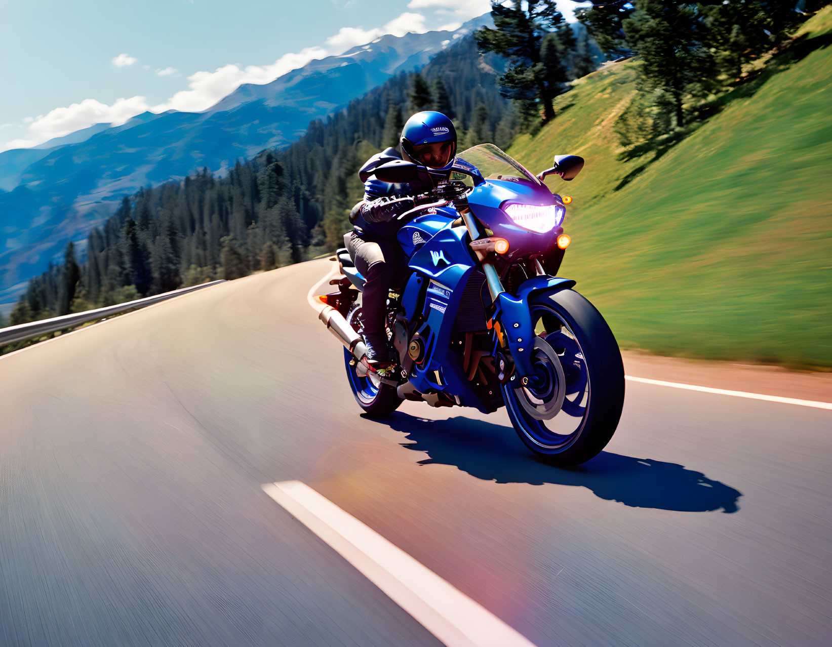 Motorcyclist in full gear riding blue sportbike on mountain road