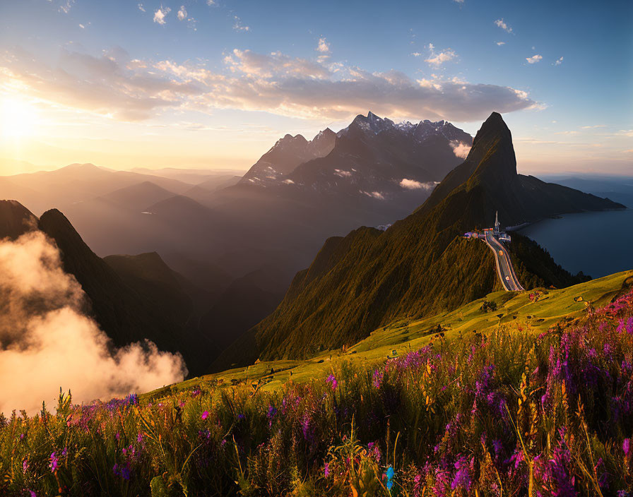 Majestic mountain range at sunset with purple flowers, winding road, and sea of clouds