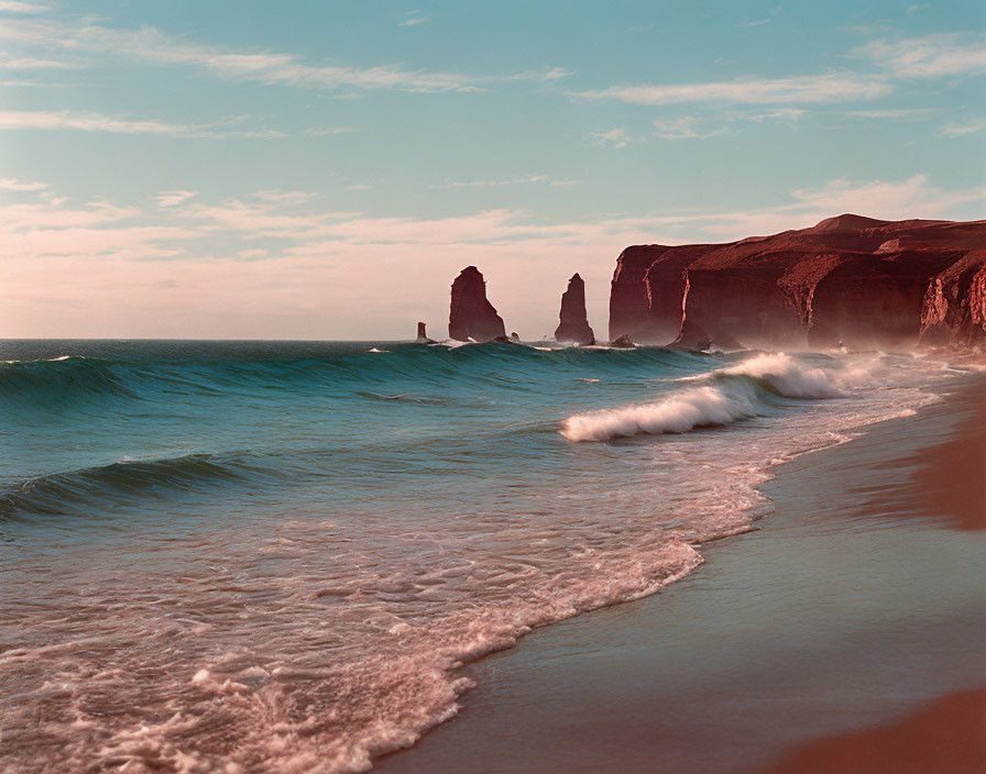 Tranquil Beach Scene with Red Cliffs and Gentle Waves