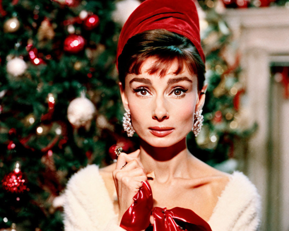 Woman in red hat and dress with fur collar near Christmas tree