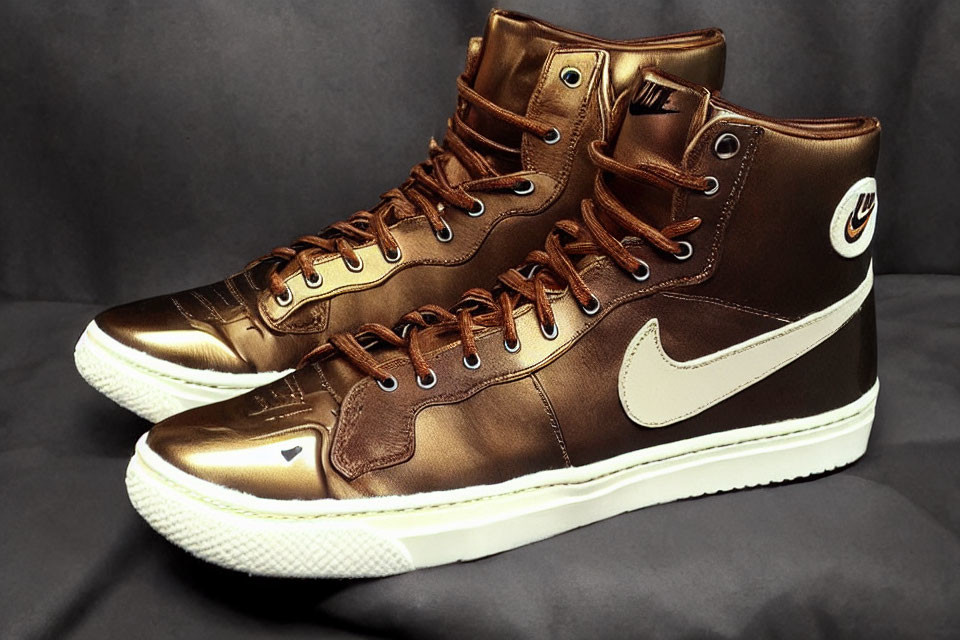 Shiny bronze high-top sneakers with white soles and swoosh logo on dark background