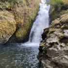 Tranquil multi-tiered waterfall in autumn setting