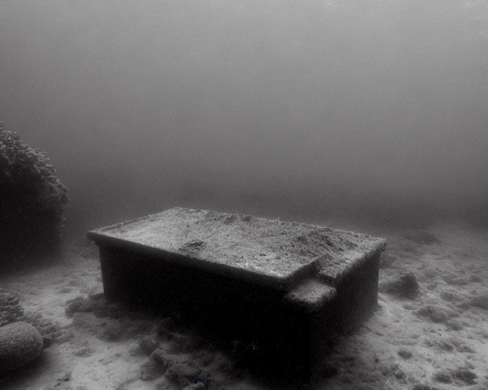 Algae-covered table in eerie underwater scene