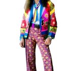 Person in Vibrant 70s-Inspired Outfit with Floral Patterns and Flared Trous