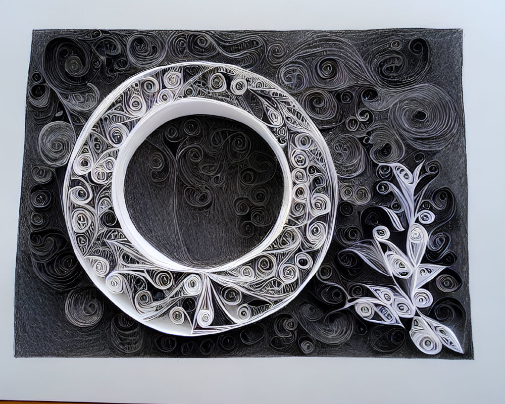 Monochrome circular paper art with intricate designs and white branch