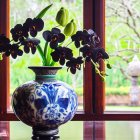 Blue and gold vase with stylized flora on art deco backdrop