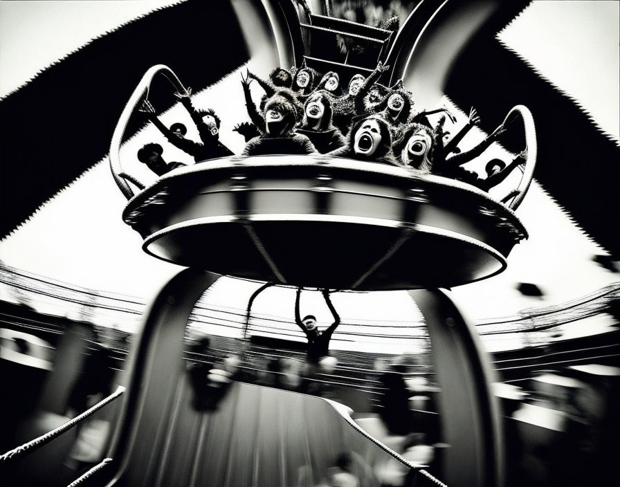 Monochrome image of spinning amusement park ride in motion