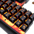 Detailed view of custom backlit mechanical keyboard with orange-red lights and unique keycap fonts