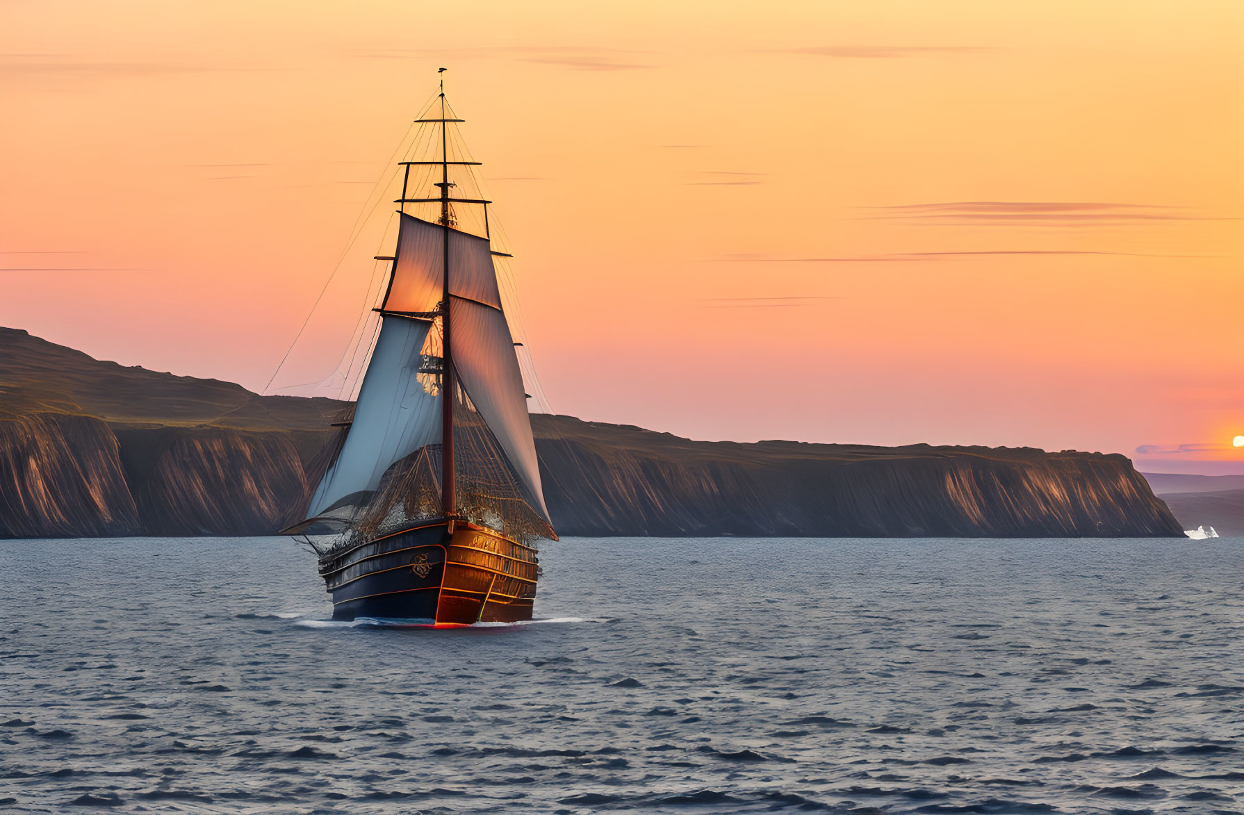 Vintage sailing ship on calm waters at sunset