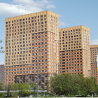 Vibrant high-rise buildings with flying fish and green kiosk in landscaped setting