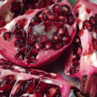 Ripe pomegranates with glistening red seeds on soft-focus background