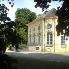 Intricate Pavilion in Lush Garden with Flowering Trees