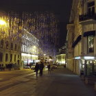 Vintage clothing street scene with vibrant storefronts and warm street lamps