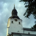 Castle tower with turrets in watercolor style against cloudy sky