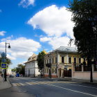 Charming street with picturesque houses and greenery under blue sky