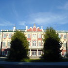 Baroque palace with gilded spires and ornate decorations against dramatic sky