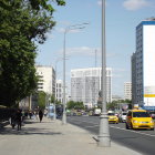 Vintage cars, pedestrians, skyscrapers in a retro-futuristic cityscape