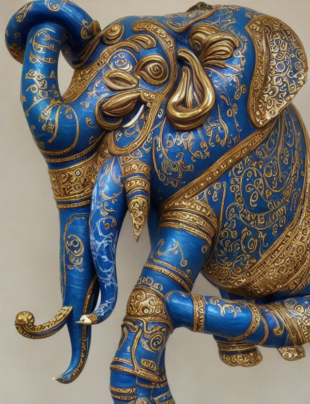 Decorated Elephant Figurine with Gold Patterns on Blue Background