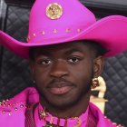 Vibrant pink cowboy hat portrait with intricate designs on a spherical pattern background