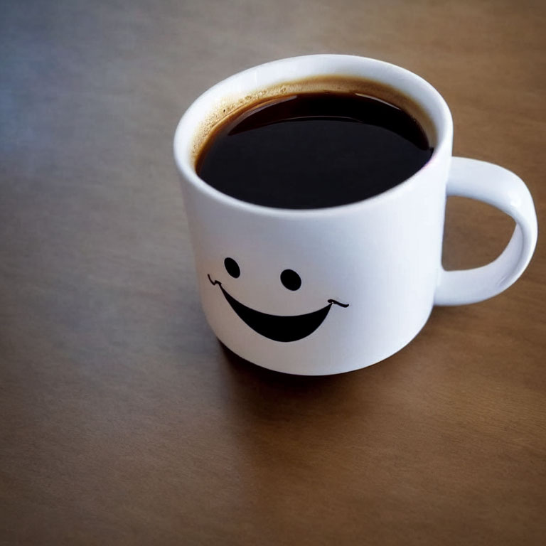 White Smiling Face Mug Filled with Black Coffee on Brown Surface