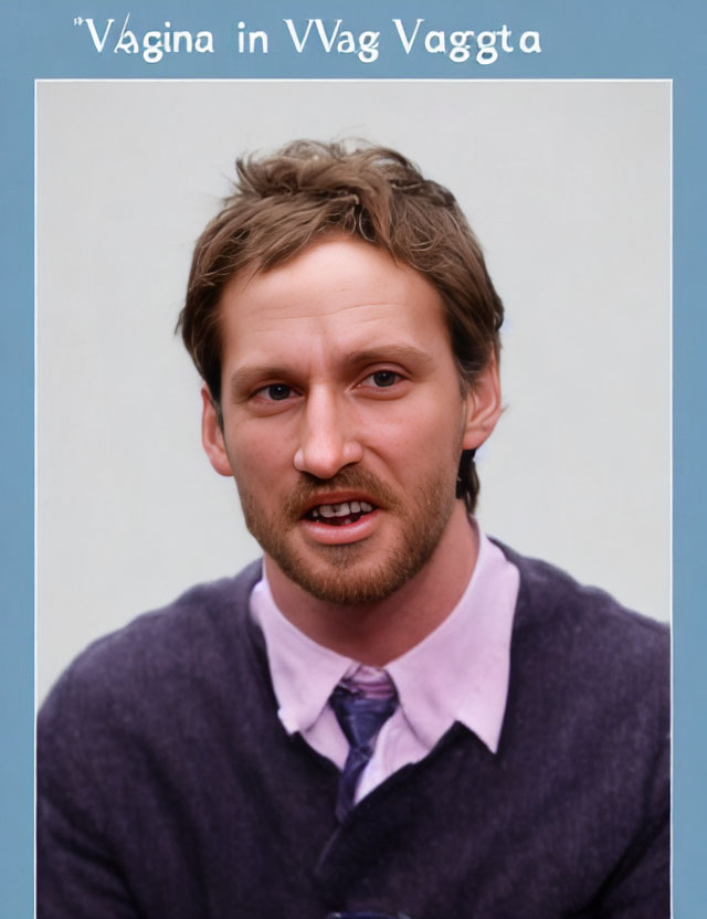 Man with messy hair in purple sweater and mustache