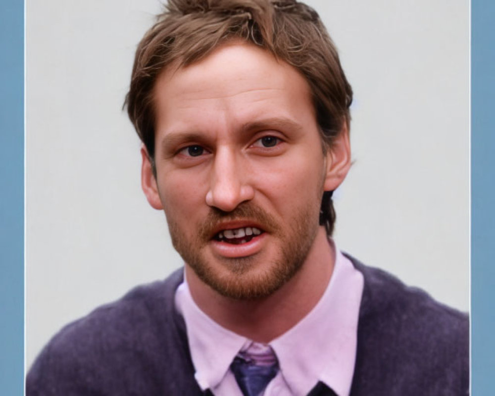 Man with messy hair in purple sweater and mustache