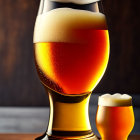 Two glasses of beer on wooden surface with warm lighting