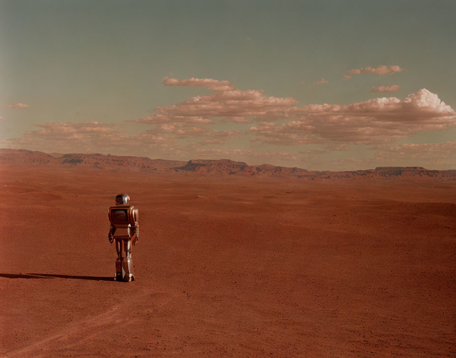 Astronaut walking on barren Mars-like landscape under clear sky