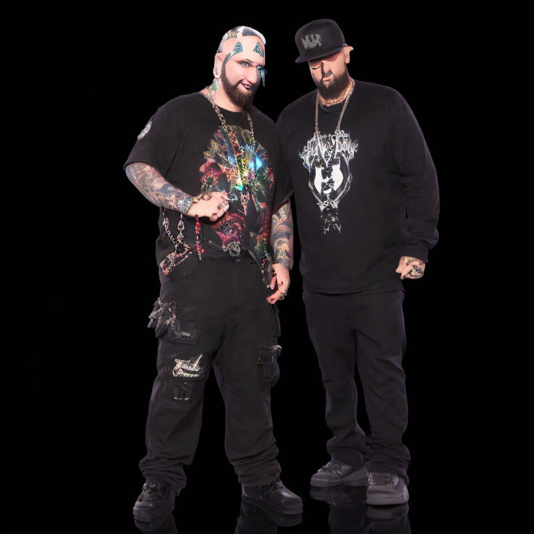 Two Men in Black Graphic T-shirt and Hoodie with Tattoos and Chain Accessories