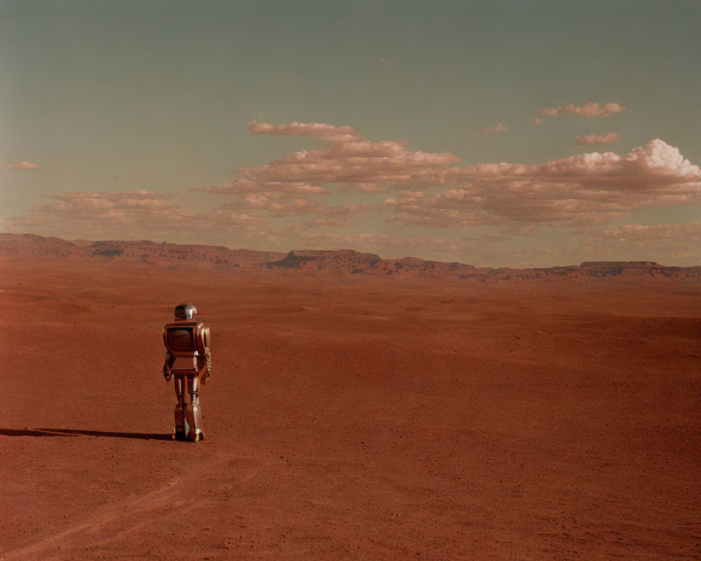 Astronaut walking on barren Mars-like landscape under clear sky