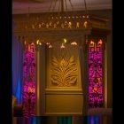 Golden wardrobe with blue and purple lighting and ornate classical design