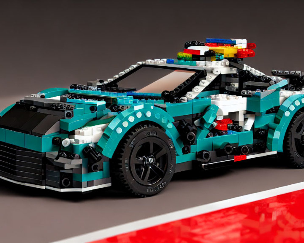 Teal Sports Car LEGO Model with Black Trim on Reflective Surface