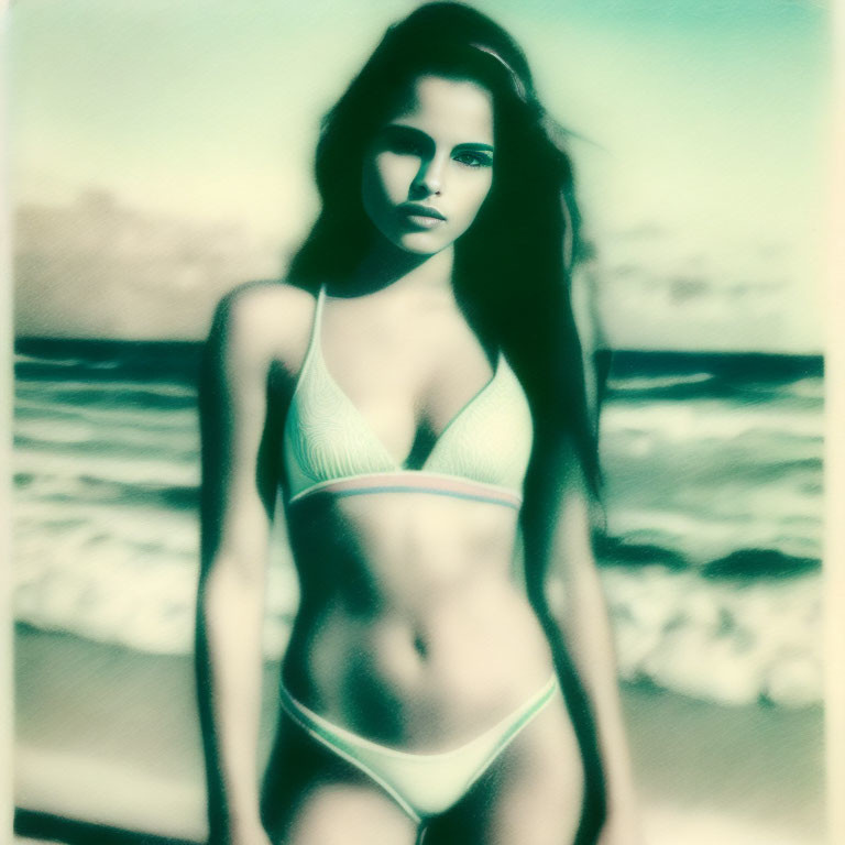 Vintage yellowish-green tinted image of woman in white bikini on beach with waves.